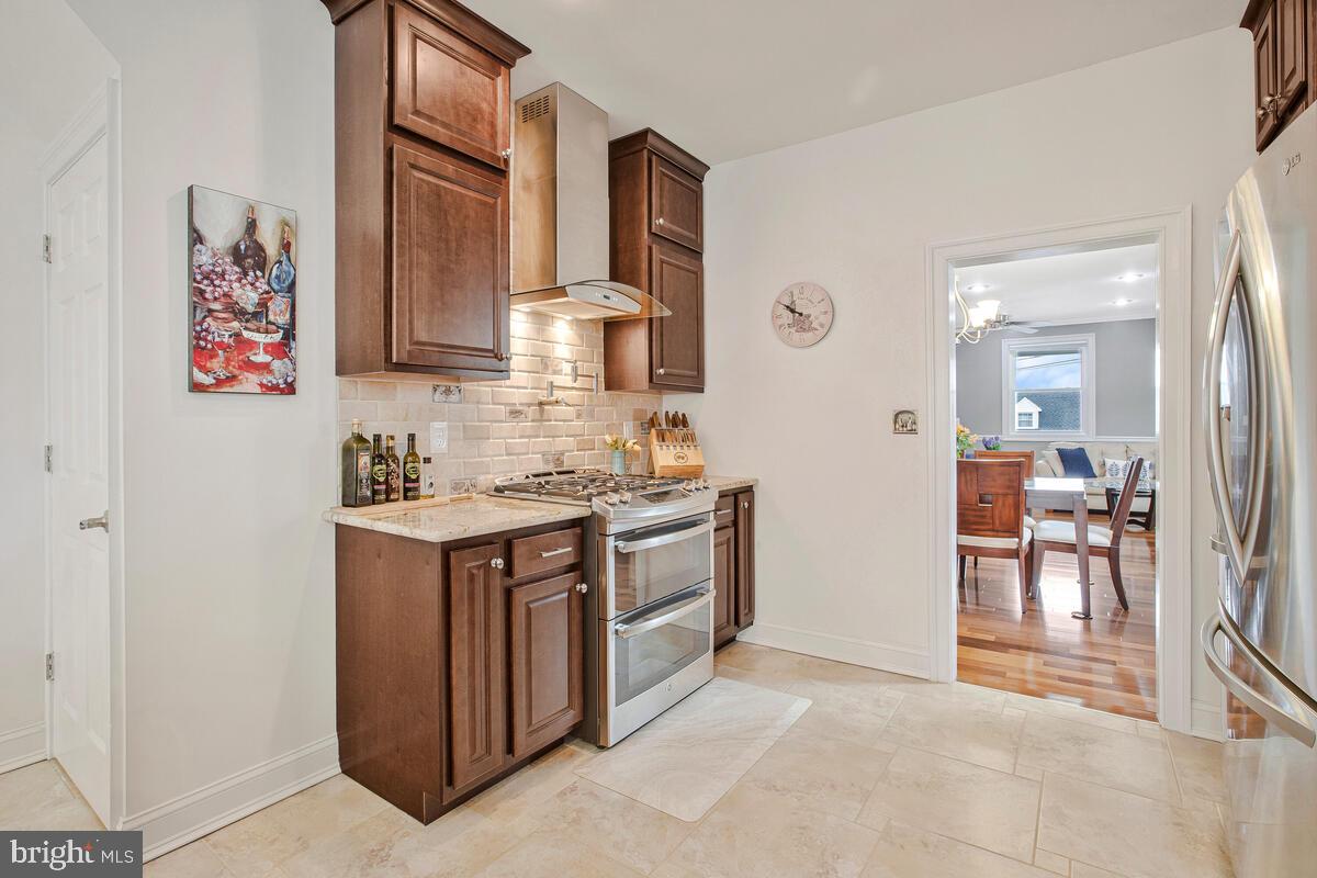 201 Charles Road Linthicum Heights, MD 21090 - Photo 14 of 50 a kitchen with stainless steel appliances granite countertop a stove and a sink