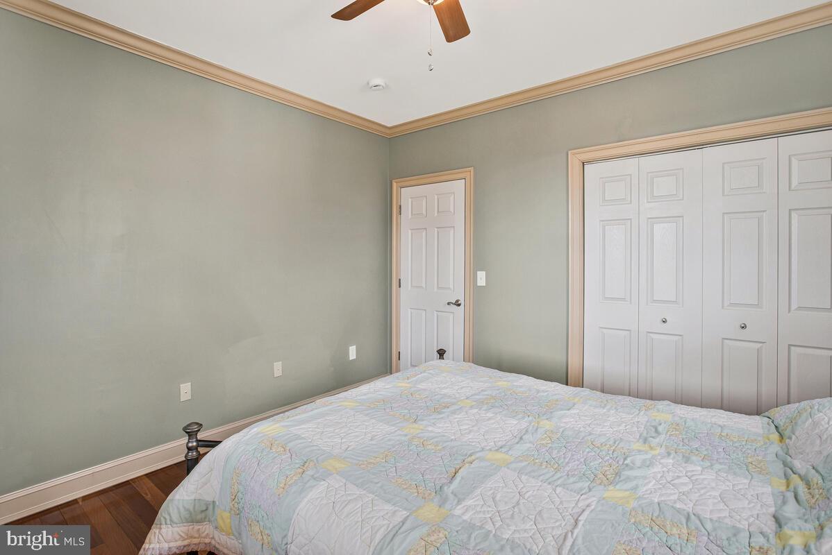 201 Charles Road Linthicum Heights, MD 21090 - Photo 19 of 50 a bedroom with a bed and a chandelier