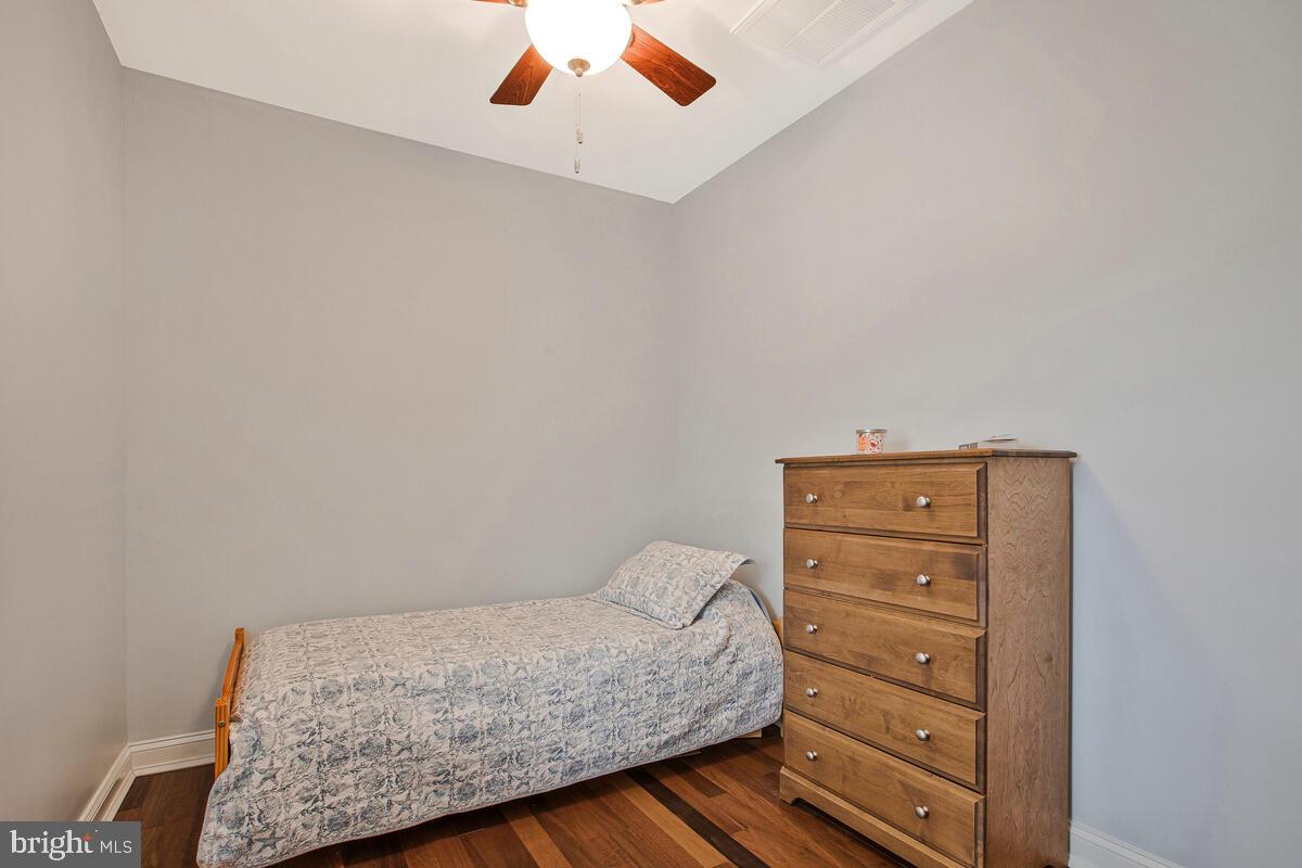 201 Charles Road Linthicum Heights, MD 21090 - Photo 23 of 50 a bedroom with a bed and a chandelier