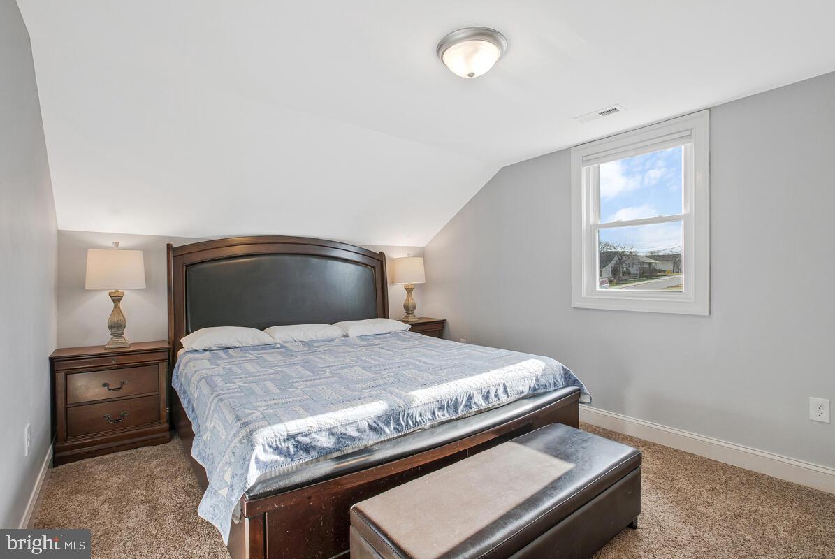 201 Charles Road Linthicum Heights, MD 21090 - Photo 27 of 50 a bedroom with a bed and a night stand