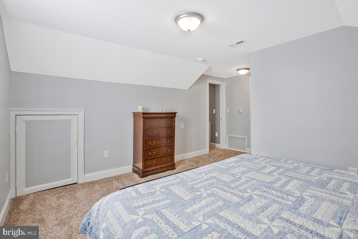 201 Charles Road Linthicum Heights, MD 21090 - Photo 29 of 50 a bedroom with a large bed and a chandelier