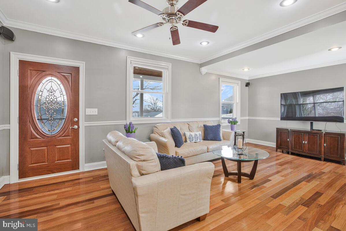 201 Charles Road Linthicum Heights, MD 21090 - Photo 7 of 50 a living room with furniture a chandelier and a wooden floor
