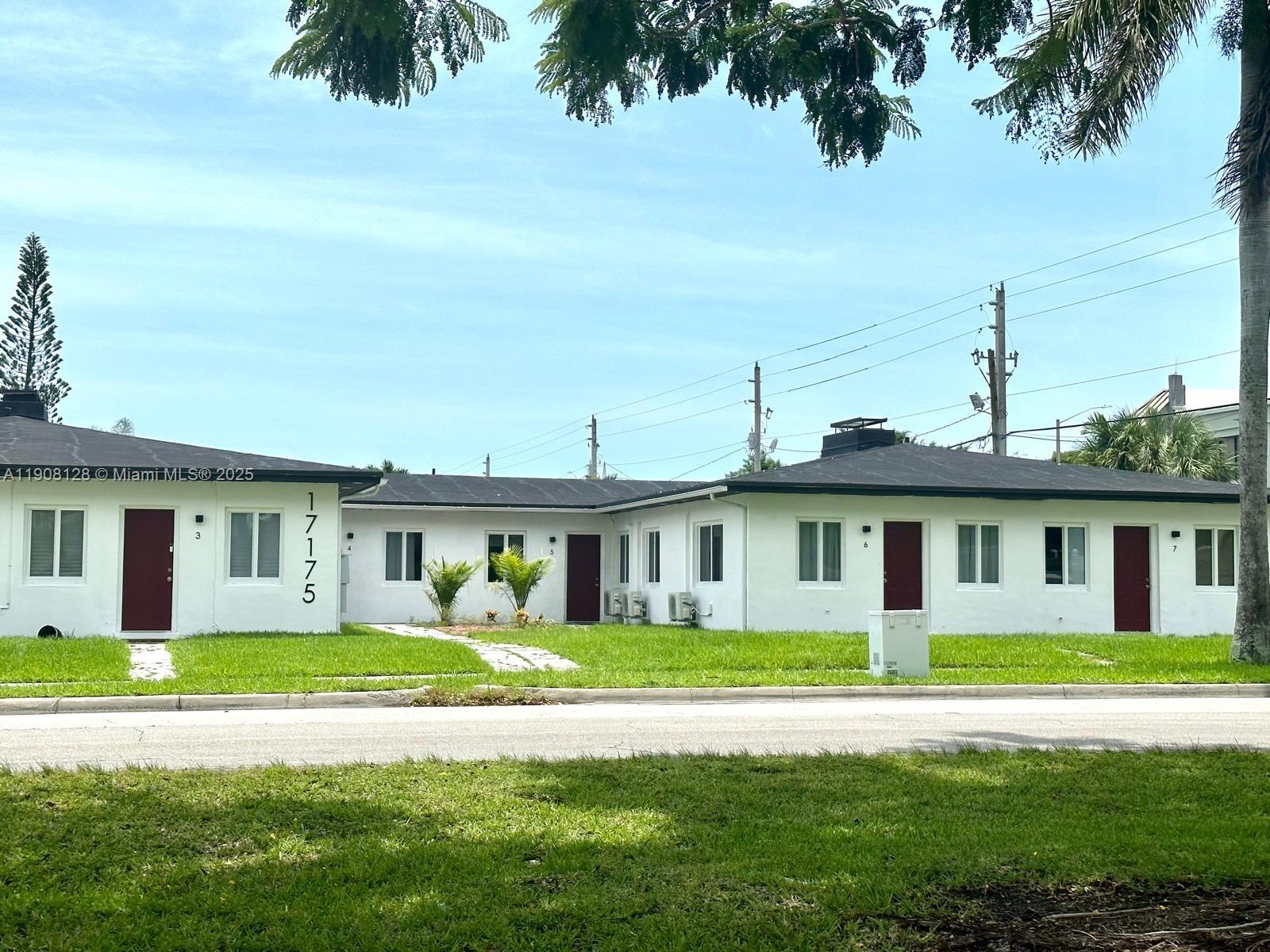 17175 Northeast 19th Avenue, Unit 6 North Miami Beach, FL 33162 - Photo 12 of 12 a front view of a house with a garden and yard