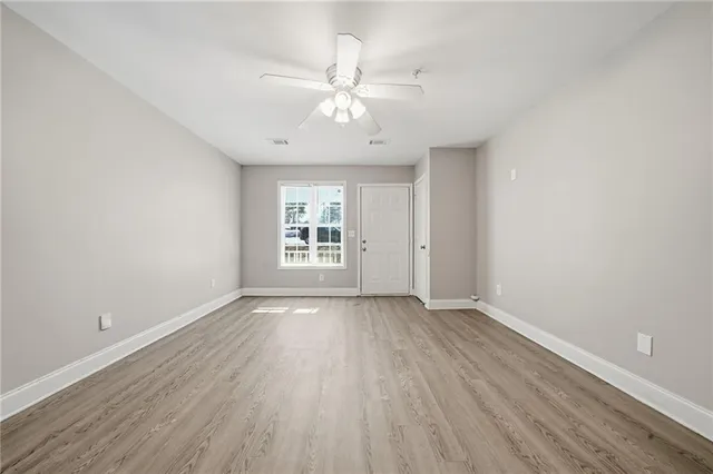 wooden floor in an empty room with a window