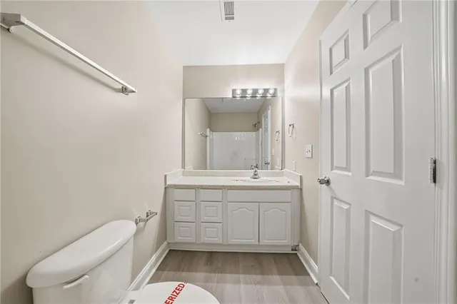 a bathroom with a sink a toilet and a mirror