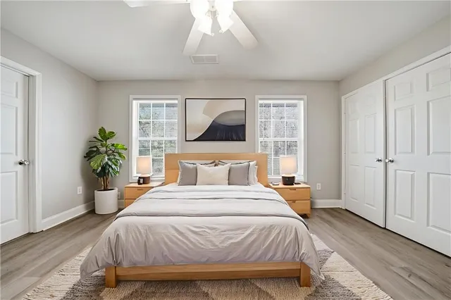 a bedroom with a large bed and a chandelier