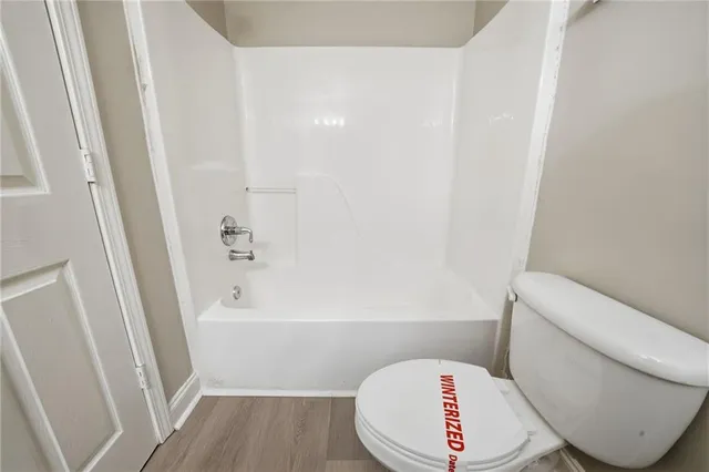 a bathroom with a toilet and a bathtub