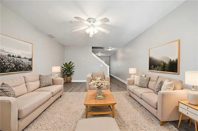 a living room with furniture and a chandelier