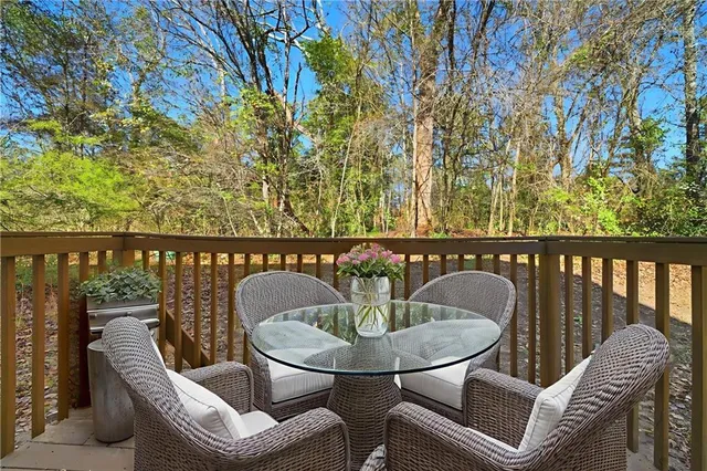 a balcony with table and chairs