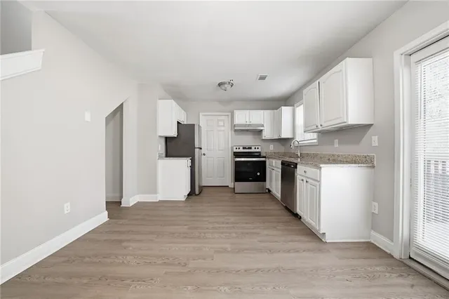a view of kitchen with wooden floor