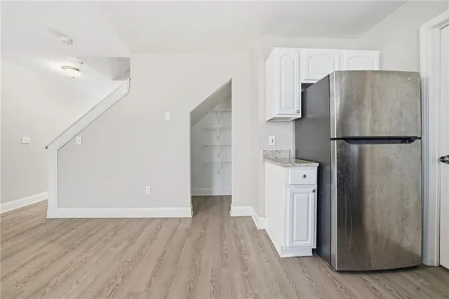 a kitchen with a refrigerator a sink and cabinets