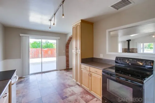 a kitchen with granite countertop a stove and a refrigerator