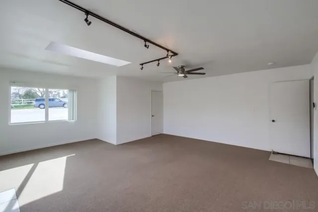 an empty room with windows and entrance