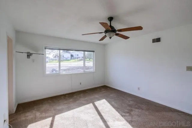a view of room with hardwood floor and window