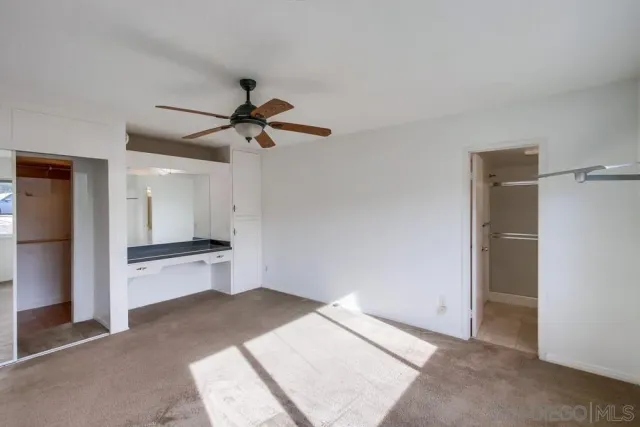 a view of a kitchen with a sink and a window
