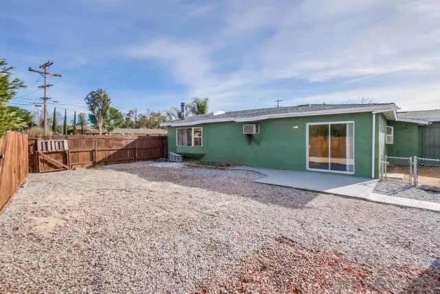 a view of a backyard with wooden fence