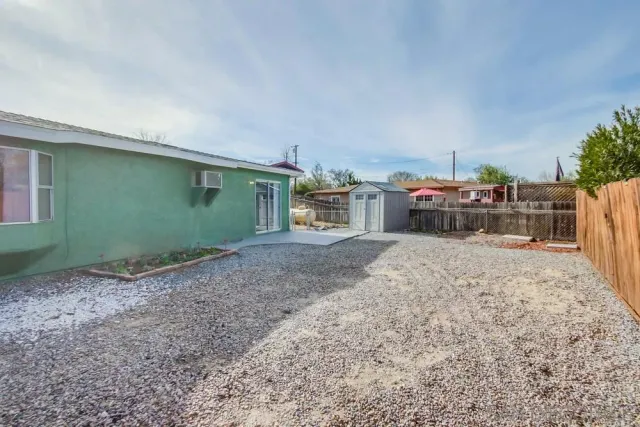 a view of a house with backyard and sitting area