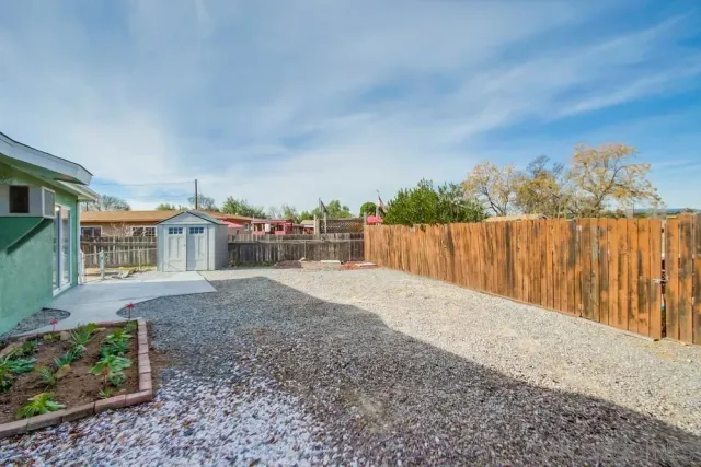 a balcony with wooden floor table and chairs