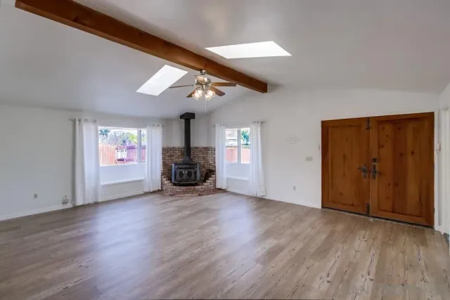 a view of a livingroom with hardwood floor and a ceiling fan