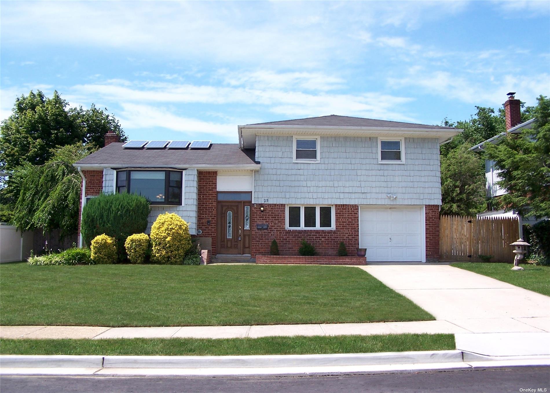 25 John Drive Old Bethpage, NY 11804 - Photo 1 of 1 a front view of house with yard and green space