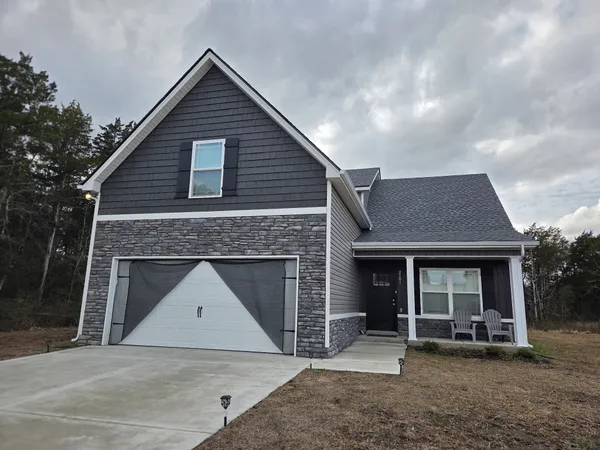 a front view of a house with a garden and porch