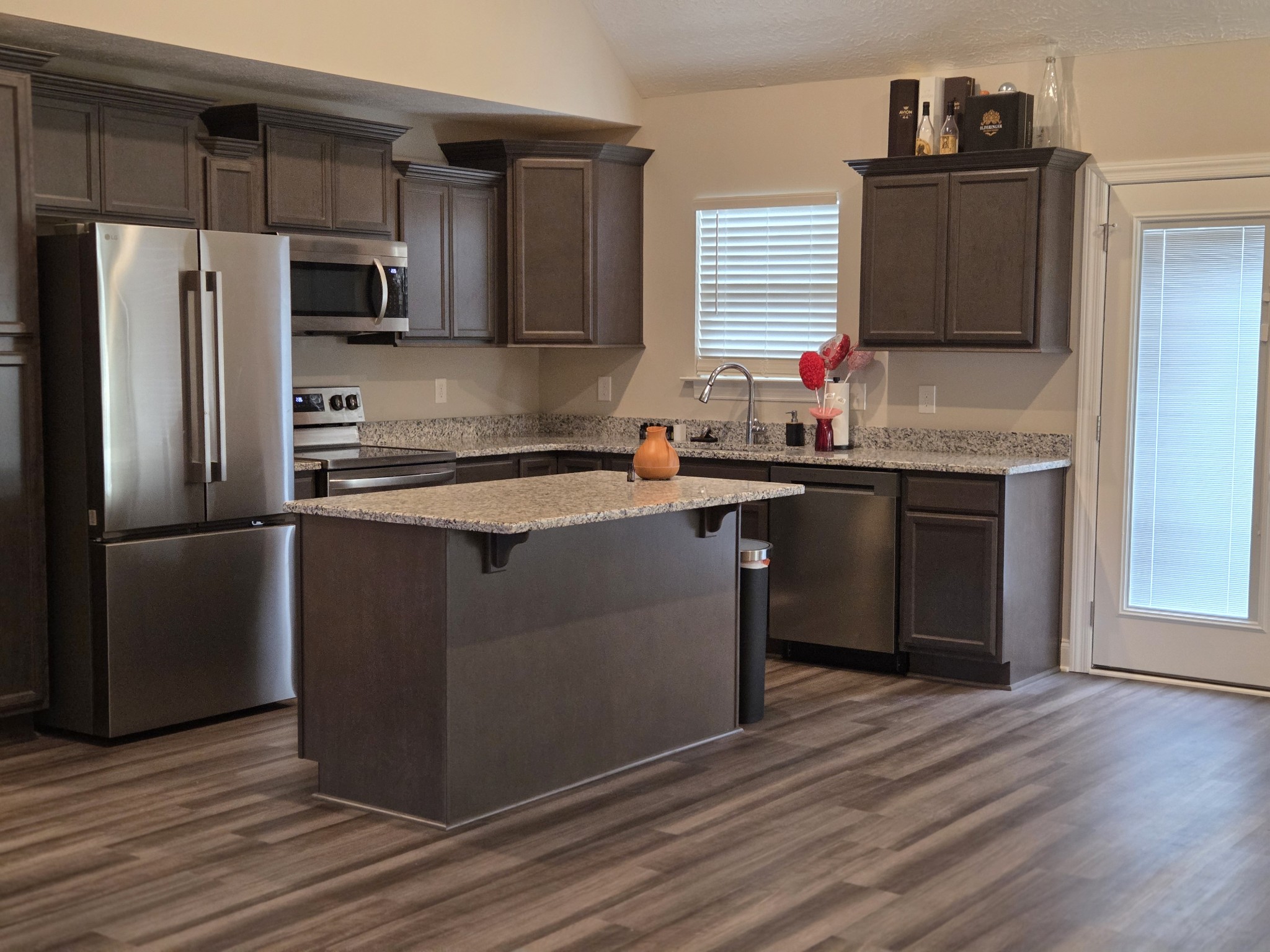 2101 Red Barn Road Christiana, TN 37037 - Photo 75 of 76 a kitchen with stainless steel appliances granite countertop a sink stove and refrigerator