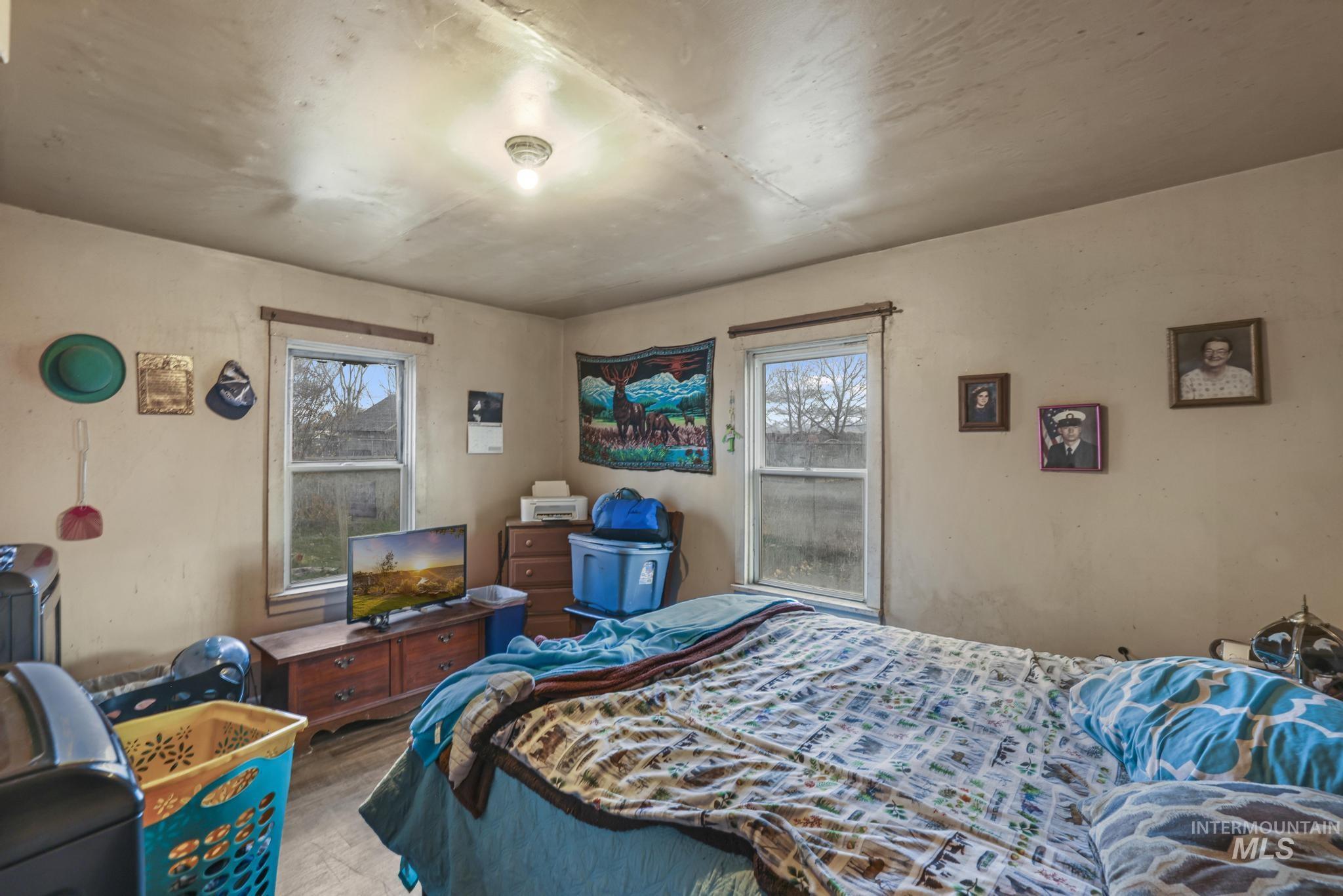 669 Locust Street South Twin Falls, ID 83301 - Photo 13 of 37 Bedroom with multiple windows and wood finished floors