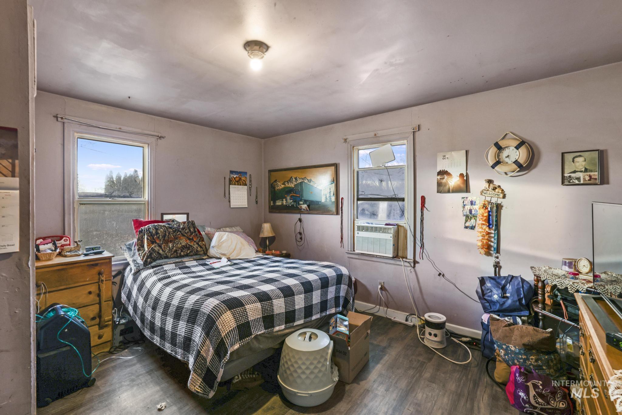 669 Locust Street South Twin Falls, ID 83301 - Photo 14 of 37 Bedroom with multiple windows, dark wood-type flooring, and cooling unit