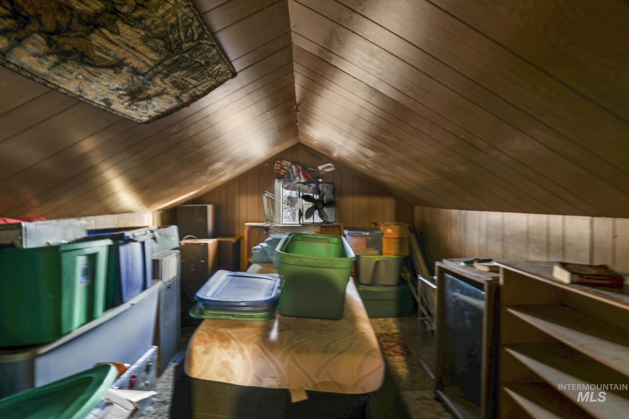 669 Locust Street South Twin Falls, ID 83301 - Photo 16 of 37 Additional living space featuring vaulted ceiling and wooden walls