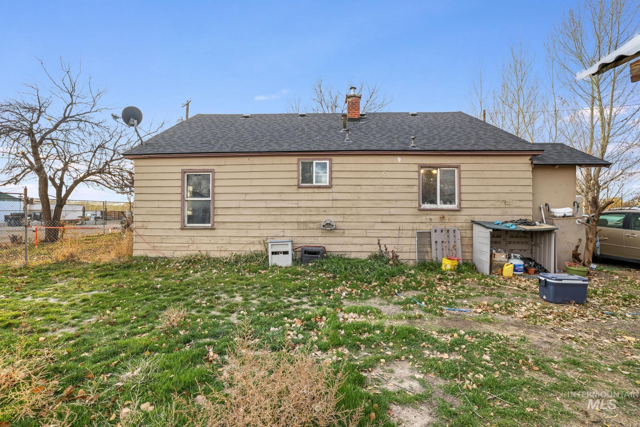 669 Locust Street South Twin Falls, ID 83301 - Photo 20 of 37 Rear view of house featuring roof with shingles and a chimney