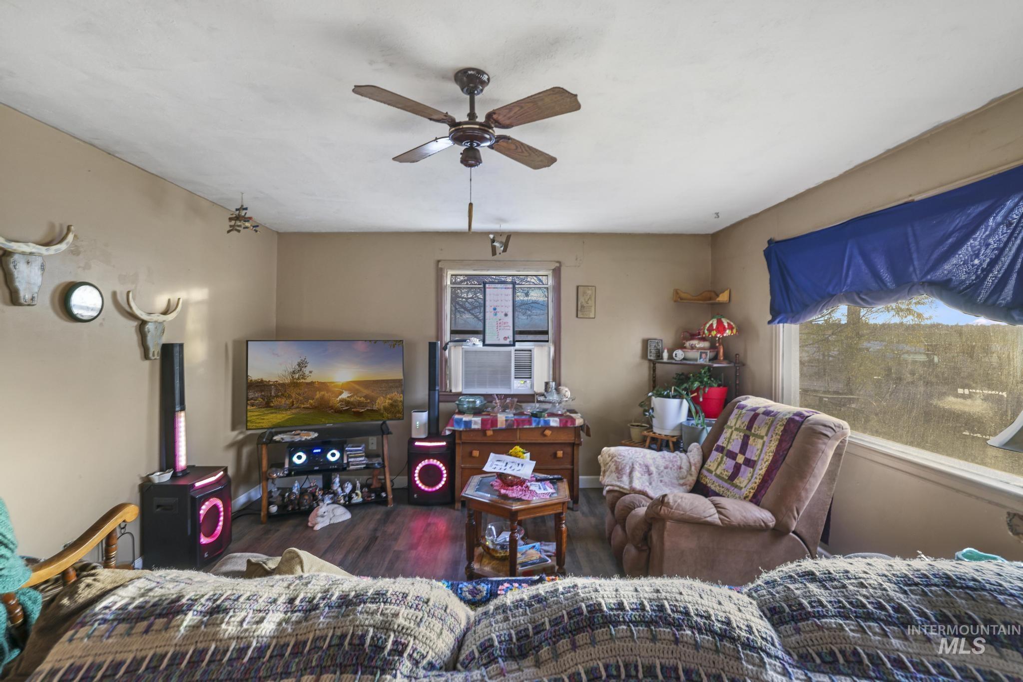 669 Locust Street South Twin Falls, ID 83301 - Photo 2 of 37 Living area featuring wood finished floors and a ceiling fan