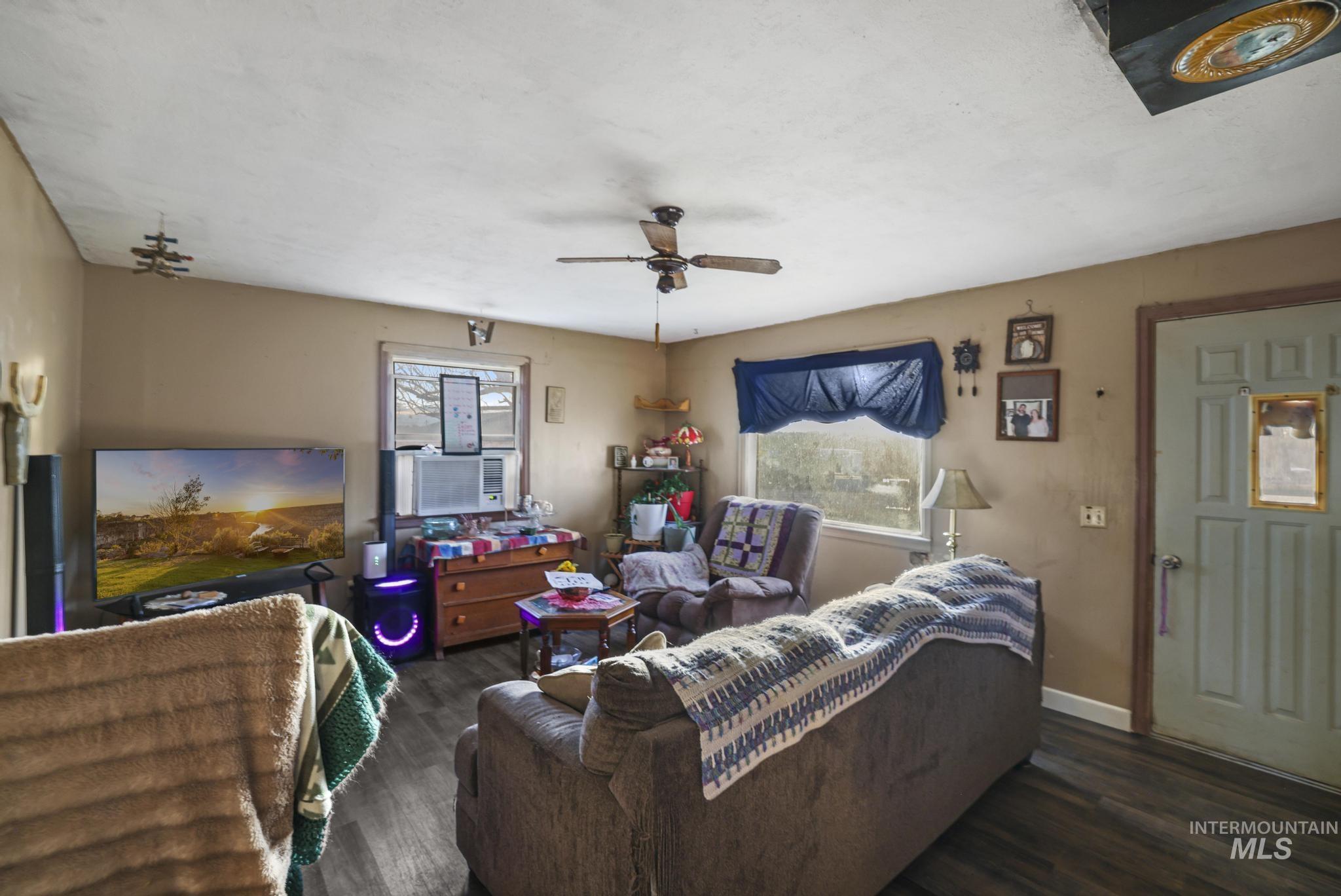 669 Locust Street South Twin Falls, ID 83301 - Photo 4 of 37 Living room with dark wood-style flooring and a ceiling fan