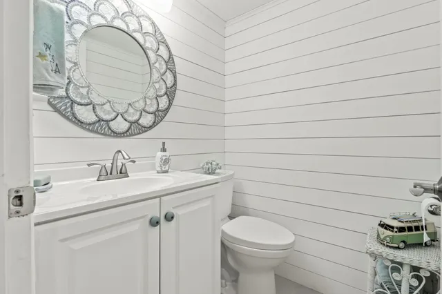 a bathroom with a sink a toilet and mirror