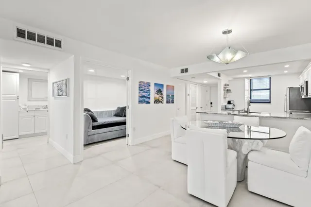 a living room with furniture white walls and white cabinets