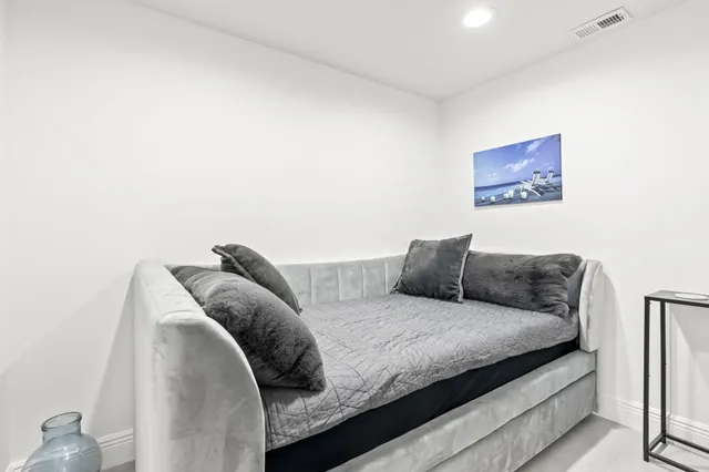 a bedroom with a bed and a painting on the wall