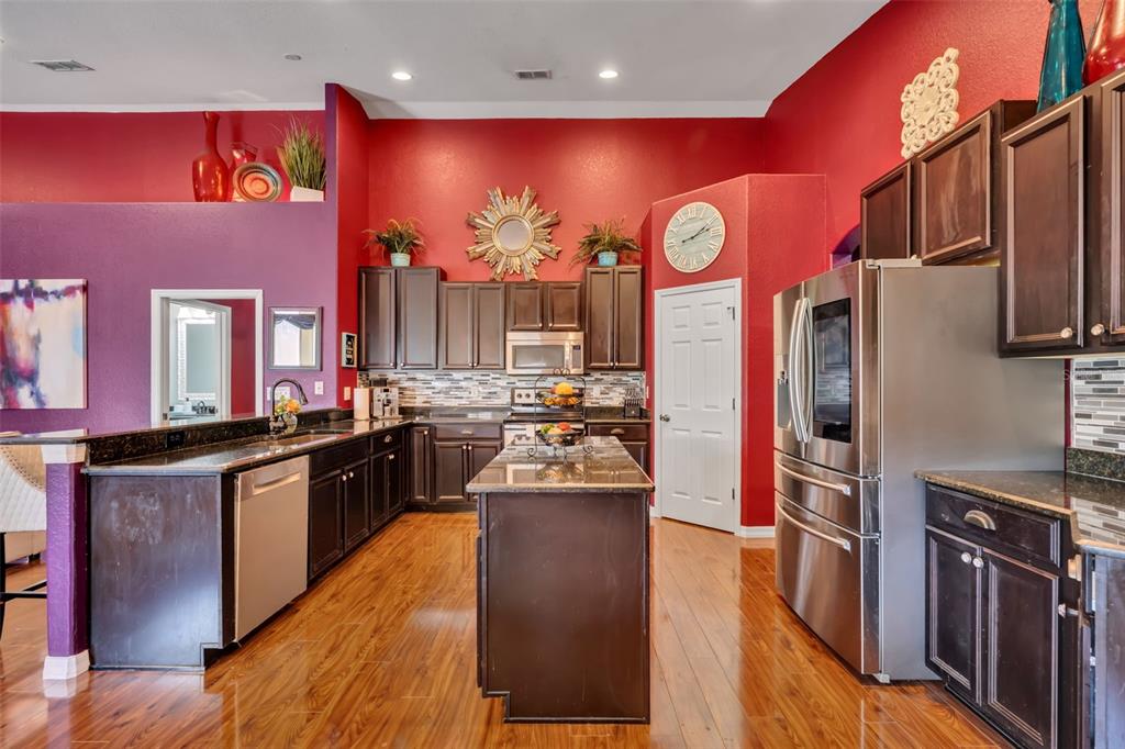 4946 Northeast 124th Road Oxford, FL 34484 - Photo 19 of 69 a kitchen with stainless steel appliances kitchen island granite countertop a stove refrigerator and cabinets