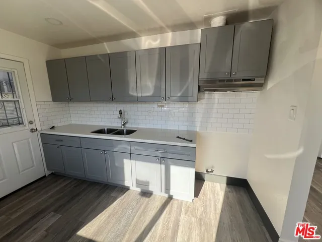 a kitchen with a sink and cabinets