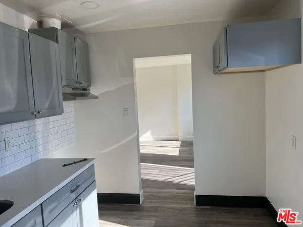 a kitchen with granite countertop a refrigerator and a sink