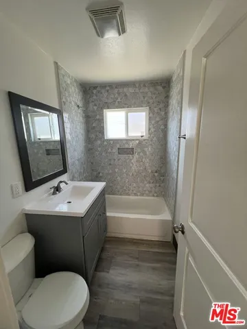 a bathroom with a sink a toilet and bathtub