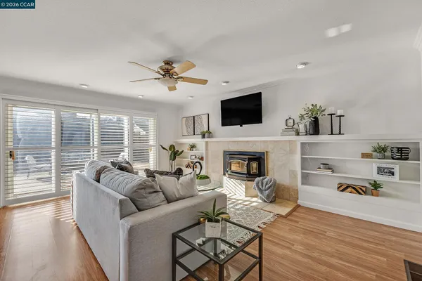 a living room with furniture fireplace and a flat screen tv