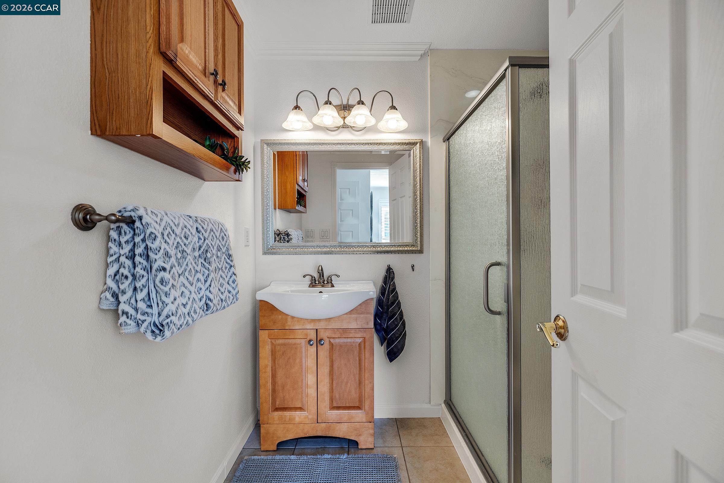 9597 Davona Drive San Ramon, CA 94583 - Photo 13 of 38 a bathroom with a sink mirror and vanity