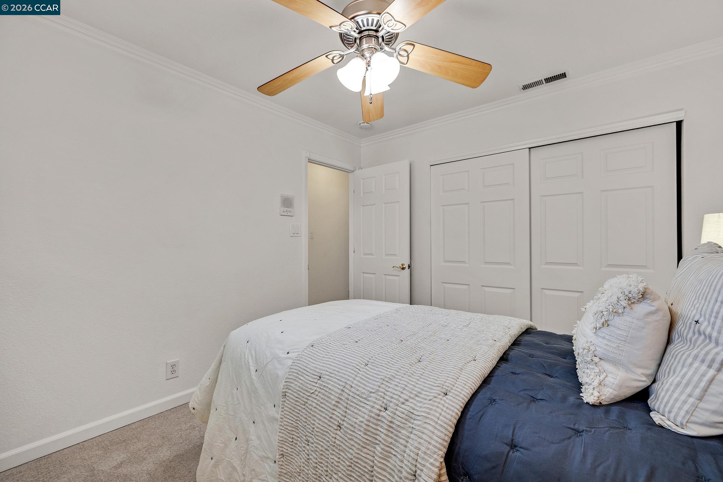 9597 Davona Drive San Ramon, CA 94583 - Photo 20 of 38 a bedroom with a bed and a chandelier