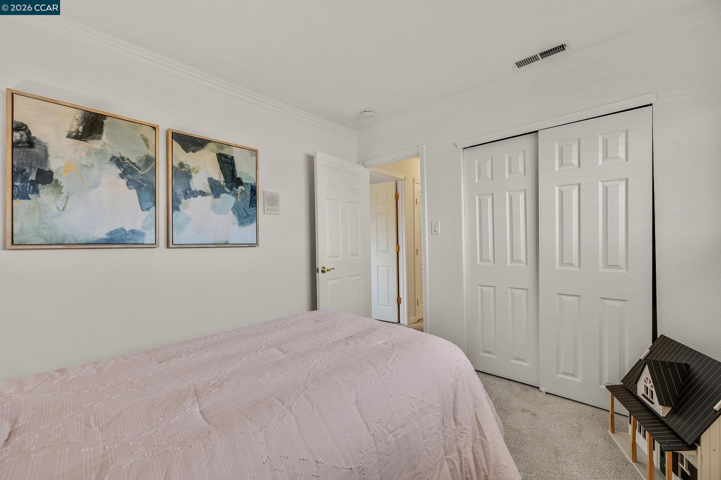 9597 Davona Drive San Ramon, CA 94583 - Photo 24 of 38 a bedroom with a bed and a painting on the wall