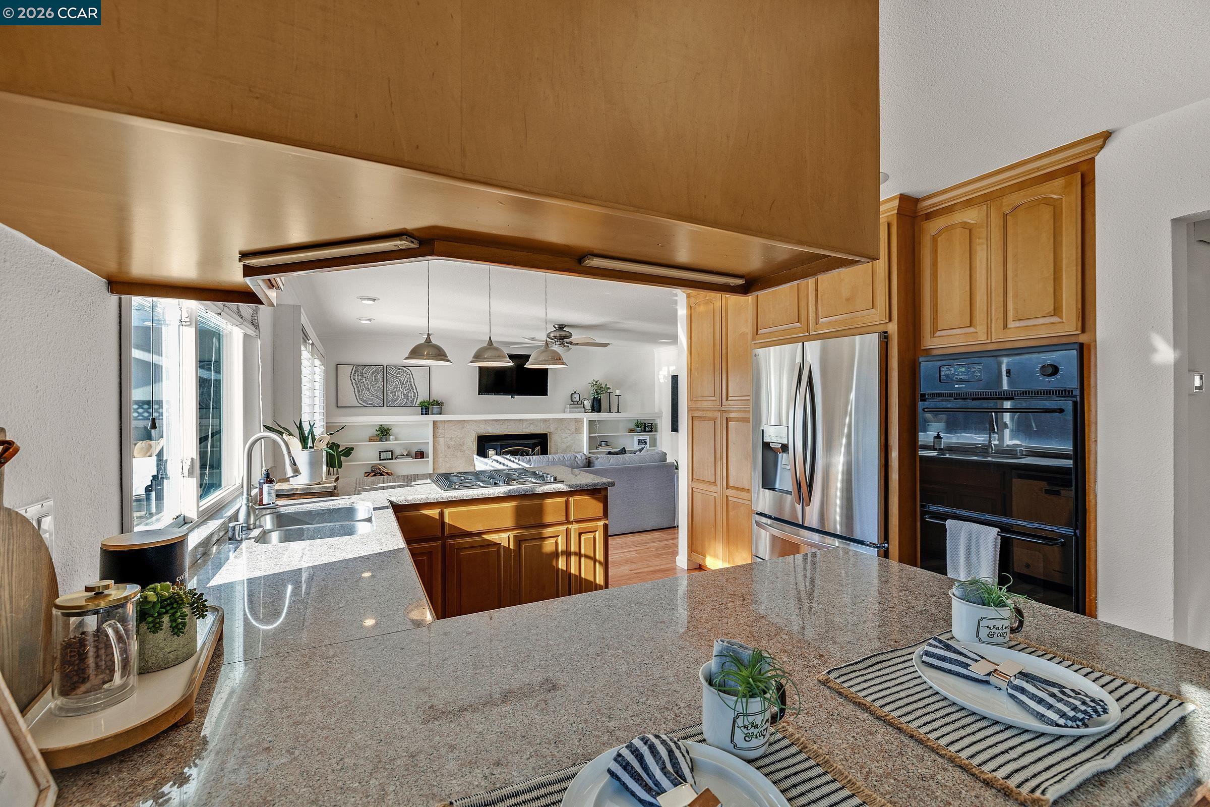 9597 Davona Drive San Ramon, CA 94583 - Photo 7 of 38 a large living room with stainless steel appliances furniture a rug and a view of kitchen