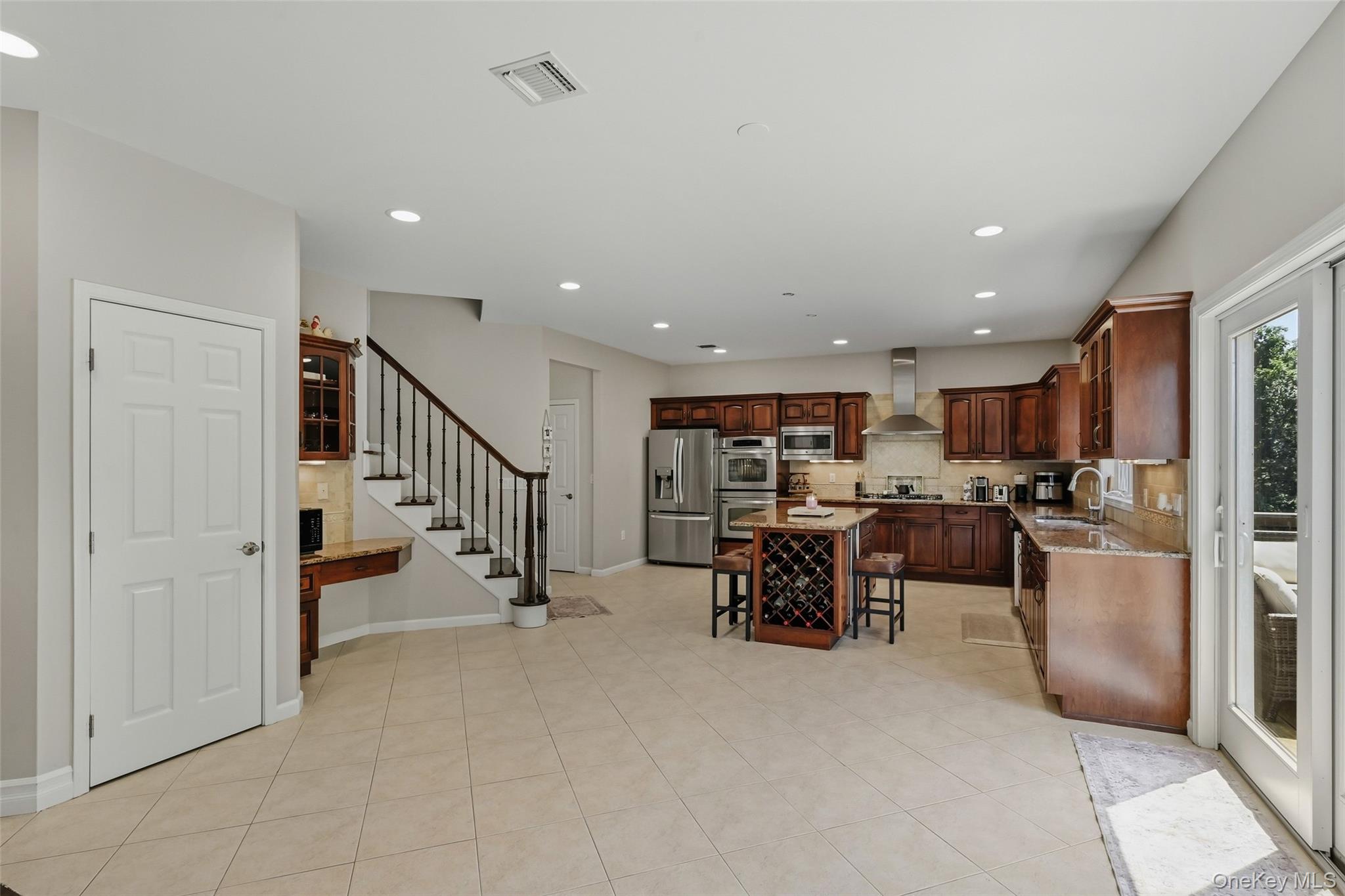 51 Meriwether Trail Congers, NY 10920 - Photo 14 of 50 Spacious open-concept kitchen featuring wood cabinetry, stainless steel appliances, and a central island with integrated wine storage