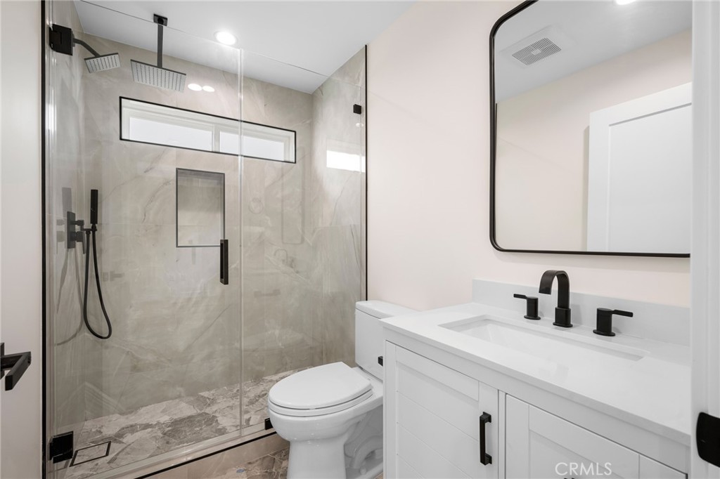 920 University Burbank, CA 91504 - Photo 13 of 20 a bathroom with a shower sink vanity mirror and toilet
