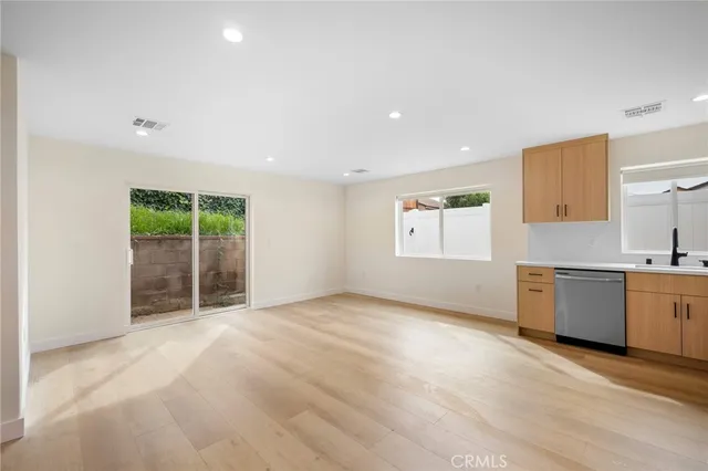 a kitchen with stainless steel appliances a refrigerator and a microwave