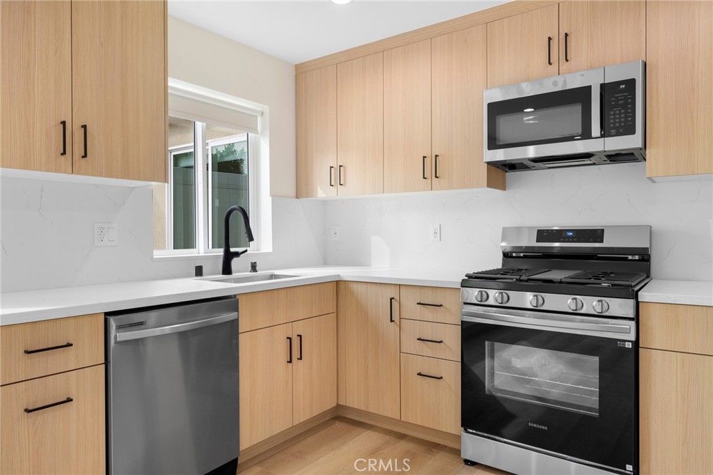 920 University Burbank, CA 91504 - Photo 8 of 20 a kitchen with stainless steel appliances granite countertop a stove top oven microwave and sink