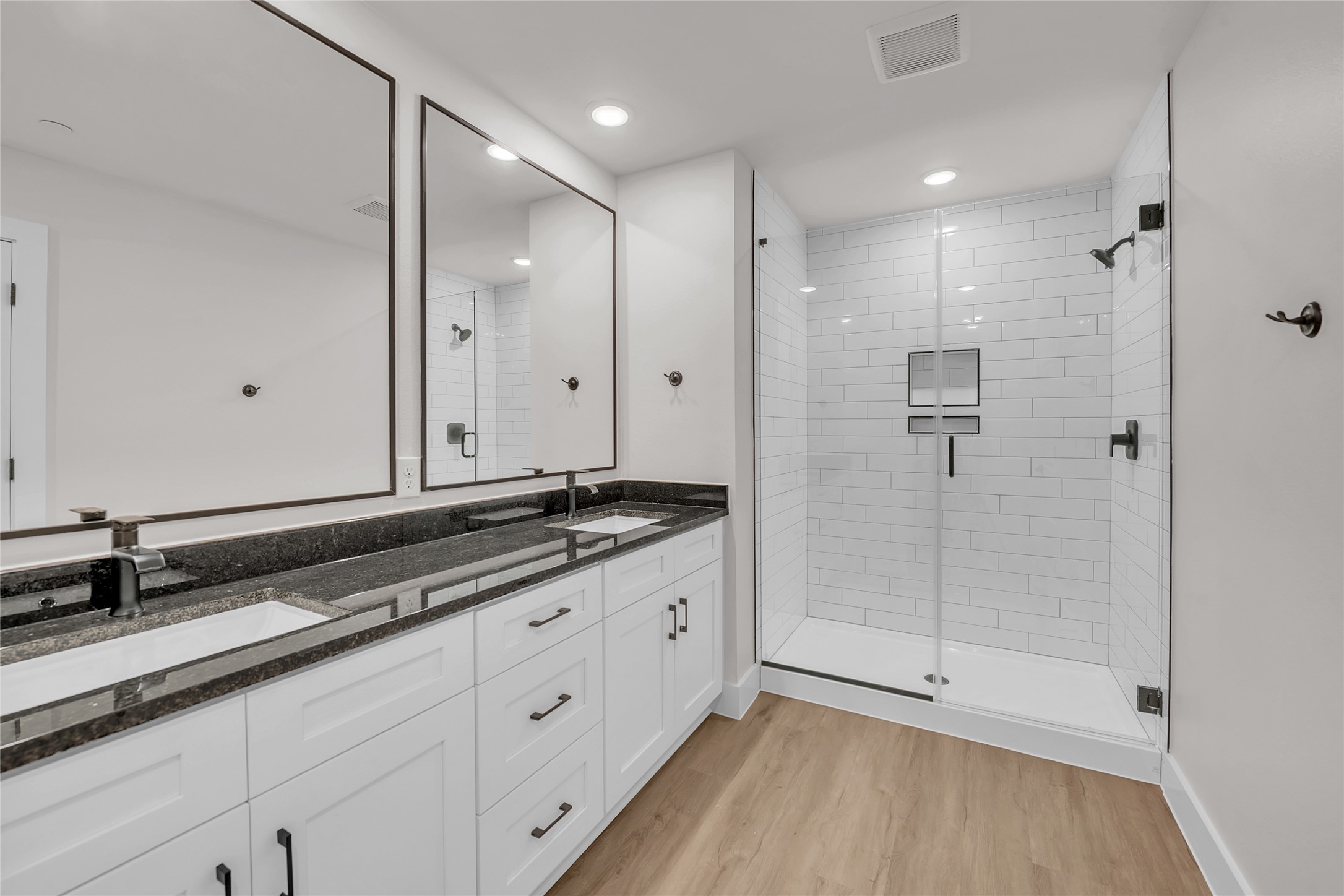 9312 Curious Squirrel Street Austin, TX 78744 - Photo 12 of 22 a bathroom with a shower sink and mirror