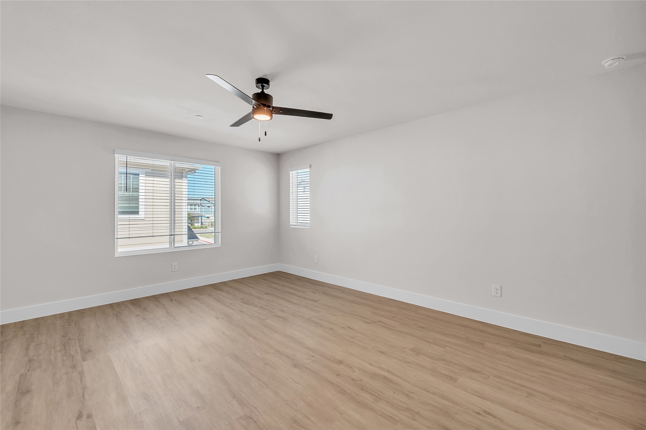 9312 Curious Squirrel Street Austin, TX 78744 - Photo 19 of 22 a view of empty room with wooden floor and fan